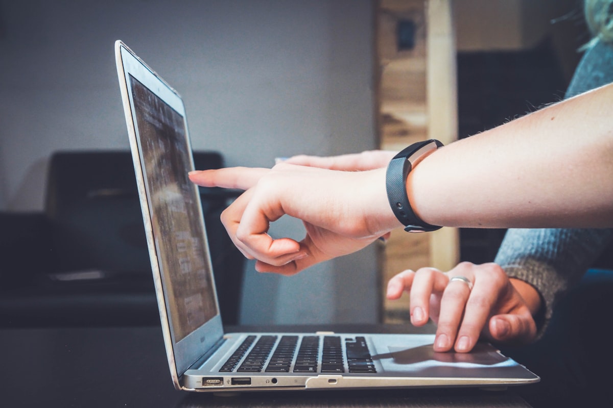 Hands interacting with a device while managing software updates