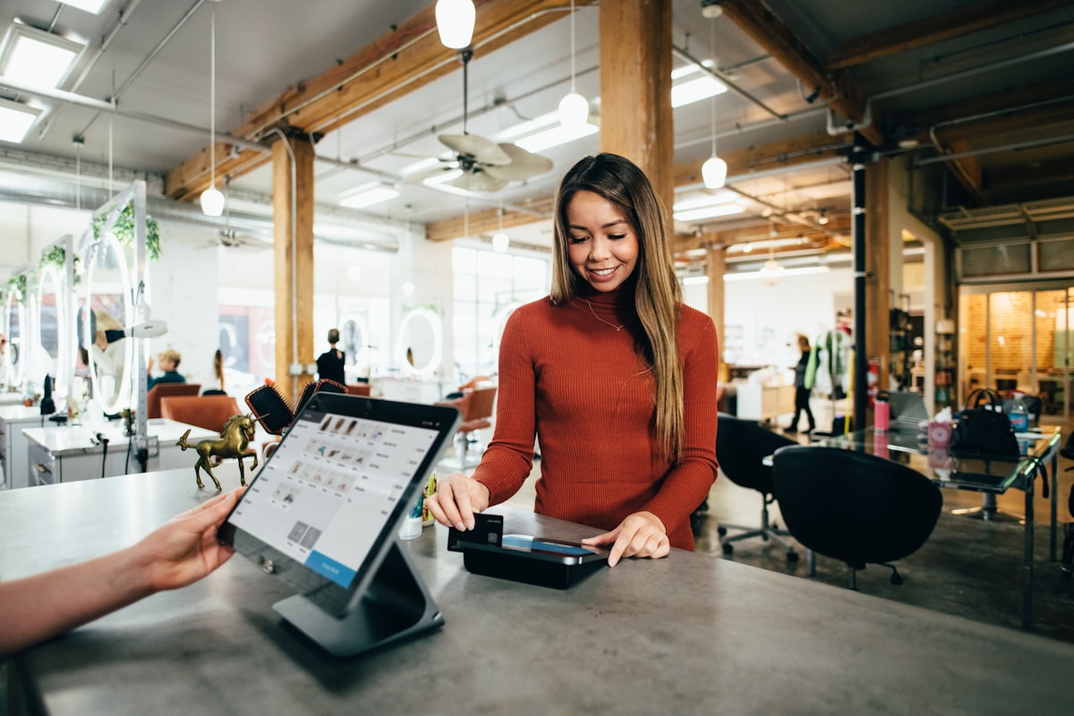Shop owner serving a customer at the counter
